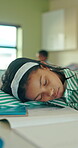 Sleeping, student or girl in classroom with fatigue from difficult math quiz, assessment or activity. Notebook, tired learner and child nap in school with burnout from learning, study and assignment.