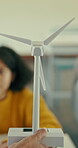 Hand, wind turbine and teaching with students in classroom for education, renewable energy and lesson. Sustainability project, future and carbon footprint lecture with children learning in school