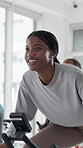 Spin class, exercise and woman with bike, fitness and training for body strength, wellness or active. Gym, endurance and people on machine for workout routine, cardio and cycling for health goals