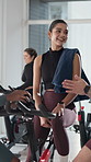 Happy, woman and talking on break, gym and training progress in spin class, discussion and together. Health club, wellness and people on bike for fitness, smile and conversation with friends or rest