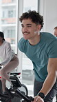 Active, man and workout with bike, spin class or training for body strength, happiness and wellness. Gym, endurance and person on machine for exercise routine, mobility and smile for health goals