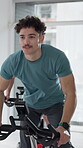 Spin class, cycling and man with bike, fitness and training for body strength, wellness and exercise. Gym, endurance and person on machine for workout routine, mobility and active for health goals