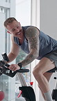 Laughing, man and fitness with bike, spin class or training for body strength, wellness and exercise. Gym, endurance and person on machine for workout routine, mobility and active for health goals