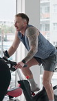 Fitness, man and cycling in spin class with bike for endurance workout, training and wellness. Person, group or energy in gym with stationary bicycle for speed challenge, cardio exercise or mobility.