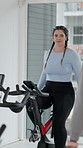 Fitness, woman and instructor in spin class with bike for endurance workout, training and wellness. Coach, group and cycling in gym with stationary bicycle for cardio challenge, exercise or mobility.