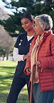 Old woman, nurse and help with walking stick at park for mobility support, rehabilitation or healing. Retirement, caregiver and senior person with cane in nature for fresh air, assistance or recovery