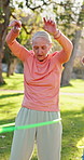 Hula hoop, fitness and senior woman in park for workout, health or wellness in retirement group. Training, equipment and elderly female person with exercise for balance, movement or class in nature.