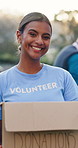 Girl, volunteer and face at park with box for donation, gift and happy with social responsibility. Woman, excited and help with call to action, accountability or smile in portrait at charity event