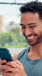 Laugh, padel and phone with man for smile, text message or social media post on court. Digital app, fitness and sports with athlete at outdoor tennis for communication, exercise or mobile update