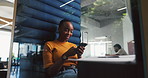 Happy woman, chatting or typing with phone in booth for social media or communication in office. Female person, employee or research with smile, mobile smartphone or cubicle for conversation or app
