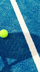Padel, ball and shadow of racket on court for competition, challenge and sports game.Club tournament, tennis contest and training with person and above on ground of turf for athlete, fitness or match