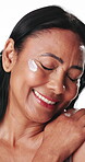 Happy, woman and skincare in studio with cream for collagen, retinol or anti aging benefits. Confident, mature female person or smile with beauty, dermatology or facial treatment on white background.