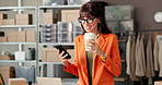 Startup, coffee and woman with smartphone, logistics and reading reviews on social media and online. Drinking, caffeine and mature person with mobile for feedback, happy and boxes in small business