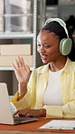 Headphones, laptop and video call with black woman in fashion startup for logistics support. Computer, smile and wave with happy African supplier at desk in office for communication or feedback
