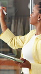 Glass wall, tablet and writing with black woman in fashion startup for planning or strategy. App, logistics and window with African supplier in office for delivery, risk management or schedule