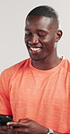 Fitness, typing or black man in studio with phone, funny message or exercise post on social media. Smile, digital or athlete on white background with mobile, wellness chat or tutorial on training app