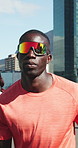 Fitness, running and man with sunglasses on city street, outdoor training and marathon practice in summer. Exercise, challenge and athlete with people for challenge, resilience and speed development