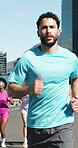 Running, fitness and cardio with man in city for challenge, training and race performance. Health, exercise and sports athlete with people outdoors for runner practice, wellness and workout group