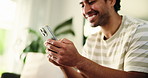 Happy, typing and hands of man with phone in home for social media, online chatting and internet on weekend. House, living room and person on smartphone for mobile app, connection or website on couch