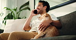 Phone call, relax and man with dog on sofa in home for communication, contact and networking. Bonding, happy and person with pet on smartphone for connection, online chat and talking in living room
