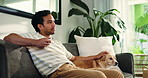 Watching tv, relax and man with dog on sofa for bonding and streaming, channel and movie on weekend. Happy, house and person with pet on couch together with remote for entertainment in living room