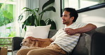 Relax, tv remote and man with dog on sofa in home for watching movie, series or show on weekend. Television, smile and male person with puppy pet in living room for streaming film in apartment.