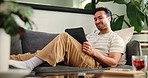 Tablet, happy and man on video call on sofa in home for communication, networking or connectivity. Relax, technology and male person on virtual conversation for contact in living room at apartment.