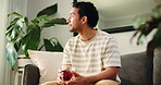 Relax, tea and thinking with man on sofa in living room of home for herbal remedy or wellness. Break, cup and vision with happy person drinking beverage in apartment for benefits or hydration
