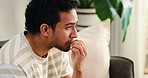 Counseling, nail bite and man on sofa with anxiety, overthinking or coping mechanism for nerves. Mental health, reflection and client in clinic for consultation, mistake or guilt in recovery.