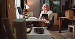 Woman, reading and tablet for ecommerce in warehouse for logistics, supply chain and catalog. Mature person, thinking and digital to confirm orders, track inventory and stock management for delivery