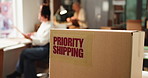 Priority shipping, box label and ecommerce office for expedited parcel, supply chain or logistics. Package sticker, cardboard and special delivery service for distribution, team and business people