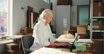 Laptop, boxes and mature businesswoman in office for logistics, delivery or supply chain with order. Computer, research and female manager with contact email for ecommerce distribution in workplace.