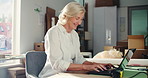 Laptop, boxes and mature businesswoman writing in office for logistics, delivery or supply chain with order. Computer, research and manager with contact email for ecommerce distribution in workplace.