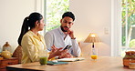 Phone, notebook and couple in home with conversation for planning financial budget together, Juice, cellphone and man with woman for payment on banking app for finance savings by table in house.