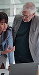 Mature, business people or explaining with laptop for project management, feedback or planning strategy. Teamwork, man and woman talking for schedule coordination, monitor progress or pointing to pc