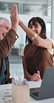 Man, woman and high five with laptop at startup, excited and success with project at media company. Mature people, team and happy for achievement, goals or celebration in office at creative agency