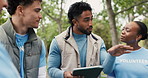 Volunteer, outdoor and people in meeting, tablet and conversation with social responsibility. Group, men and women in park, tech and discussion with charity event, community service and digital app