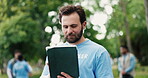 Volunteer, man outdoor and scroll with tablet for NGO donation website, outreach or nonprofit service. Bokeh, person and reading with tech in park for charity work, community empowerment and project.