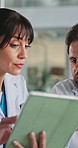 Meeting, team and doctors on tablet in hospital for surgery schedule, feedback and diagnosis. Healthcare, collaboration and woman with man on digital tech for medical report, research and advice