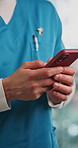 Hands, phone and nurse with texting in clinic, contact and advice with telehealth consulting in hallway. Person, smartphone and medical professional with scroll, chat and mobile app at hospital