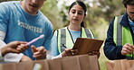 Charity, volunteers and people with clipboard, park and inventory for community service and writing. Outdoor, group and coordinator with checklist for inspection, donations and supply distribution