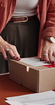 Woman, hands and logistics with label on box for online delivery, shipping or courier service. Closeup, female person or instructions with package, address or brand for small business distribution
