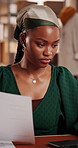 Logistics, laptop or black woman in small business with paperwork, planning inventory or order. Computer, document or ecommerce entrepreneur with stock update, delivery schedule or shipping in office