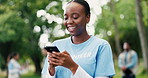 Funny, phone and volunteer woman in park for charity, community outreach or donation update. App, laughing and typing with happy person outdoor for social media post of ngo or non profit mission