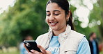 Laughing, phone and volunteer woman in park for charity, community outreach or donation update. App, funny and typing with happy person outdoor for social media post of ngo or non profit mission