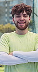 Smile, arms crossed and face of man on tennis court for fitness, competition and sport athlete. Club tournament, portrait and confidence with person on outdoor turf for contest, games and workout