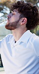 Tennis player, man or drinking water with bottle for sports hydration, match or competition break. Active, happy person or athlete on court with beverage for electrolytes, tournament rest or recovery