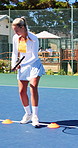 Woman, tennis and cones on court for drill fitness, agile practice and coordination training. Athlete, person and footwork with racket, sports endurance and speed technique for tournament preparation