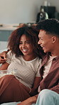 Couple, popcorn and watching tv on sofa for love, date or bonding together in home. Snacks, subscription or man on couch with woman and romance for streaming film, television or series in house