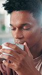 Aroma, happy and man with coffee in home for calm, wellness and peaceful morning on weekend. Apartment, thinking and person with caffeine, drink and beverage for comfort, energy and relax in house